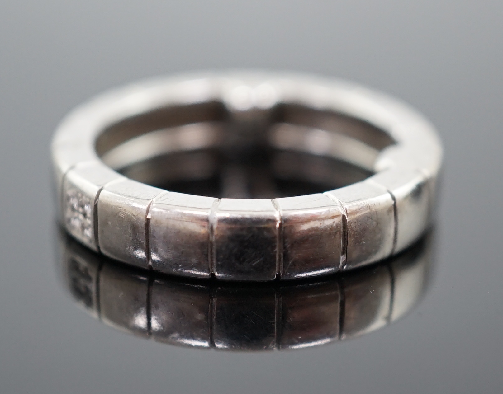 A modern Chopard 18ct white gold and four stone diamond chip cluster set band